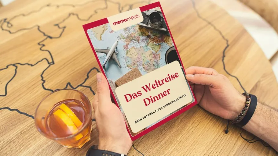 Person holding travel-themed dinner book.