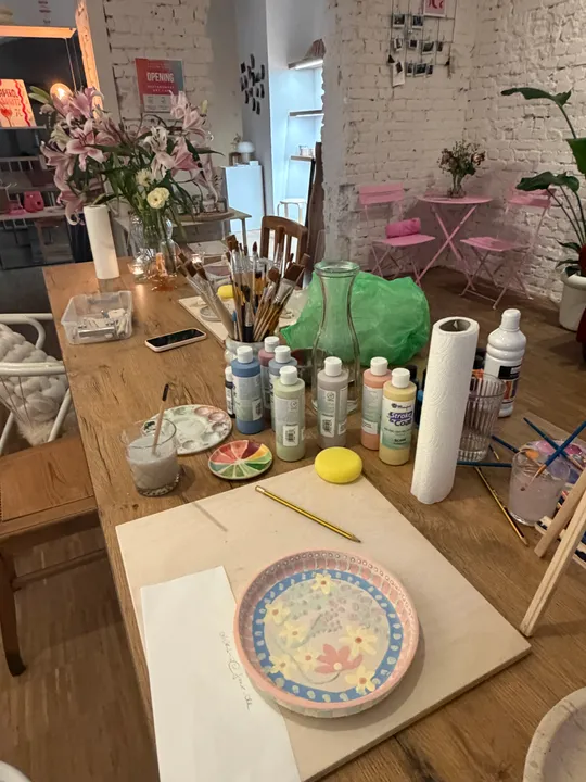 Art studio table with paints and brushes.