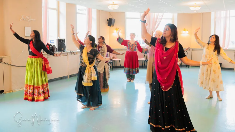 Women dancing in a bright studio.