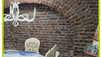 Dining area with brick arch background.