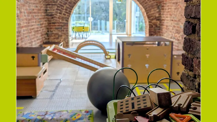 Playroom with toys and climbing structures.