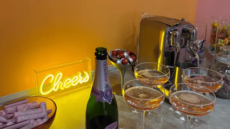 Champagne glasses and machine on a table.
