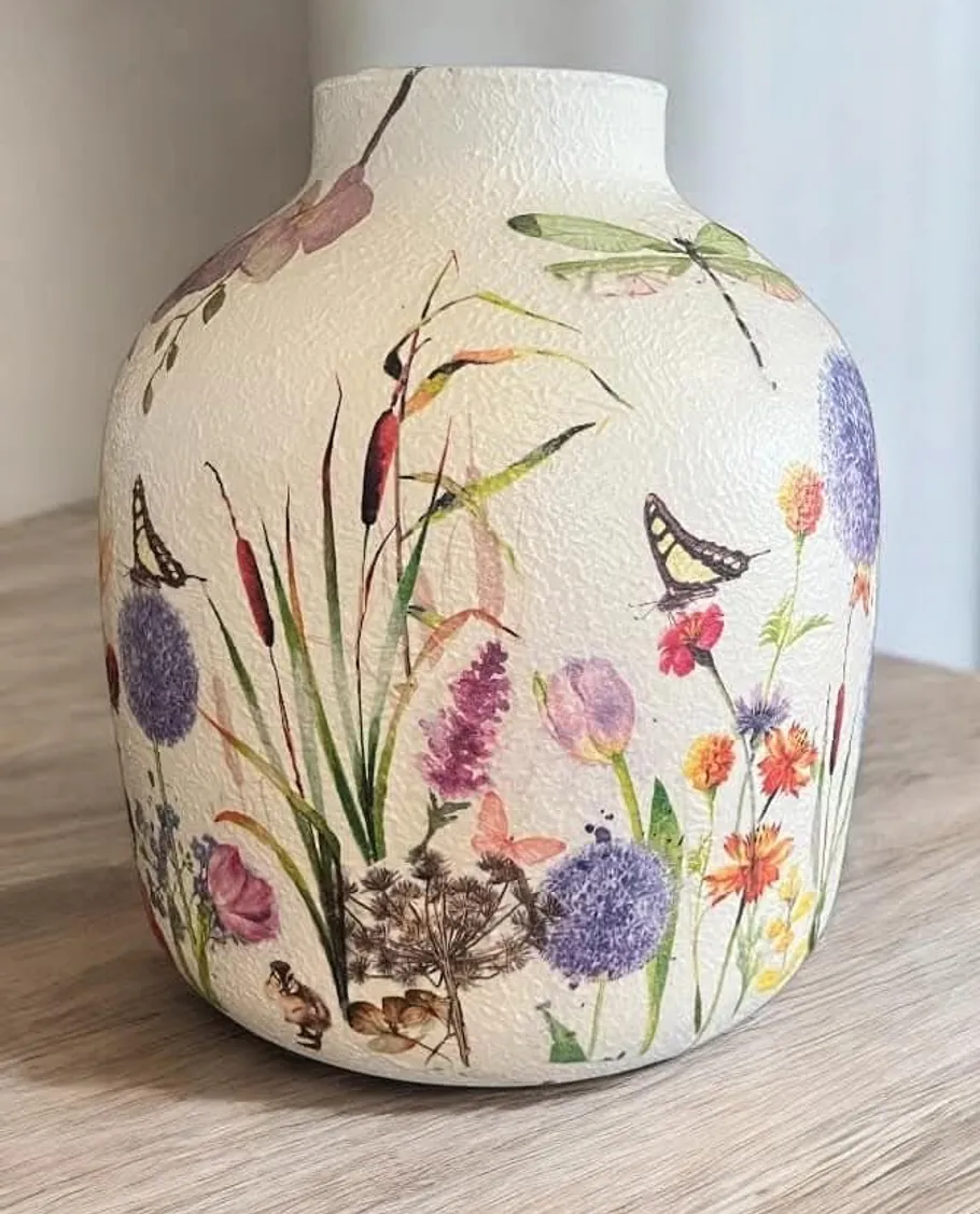 Decorative vase with floral and insect design.