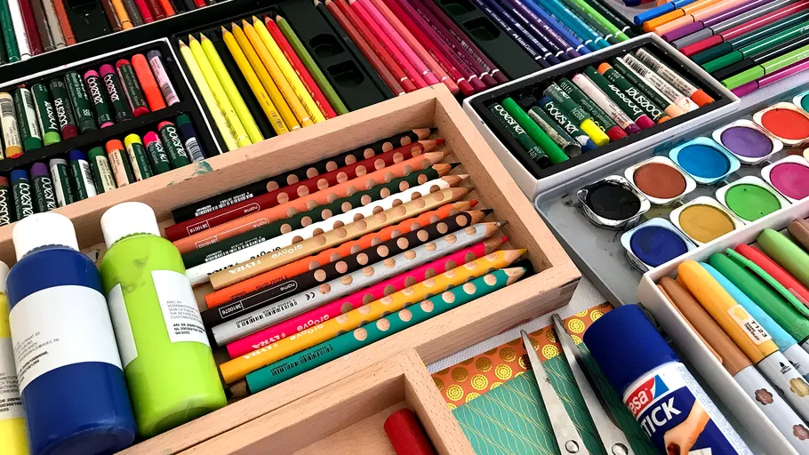 Colorful art supplies arranged on a table.