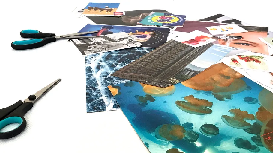 Scissors and cut-out images on a table.