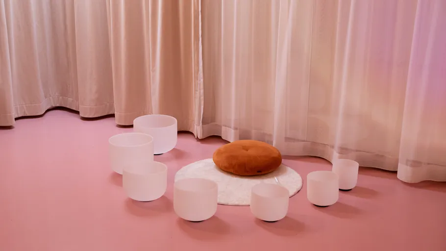 Crystal bowls arranged around a cushion indoors.