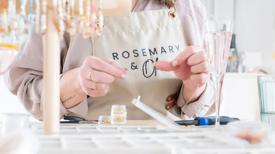 Person crafting jewelry in a studio setting.