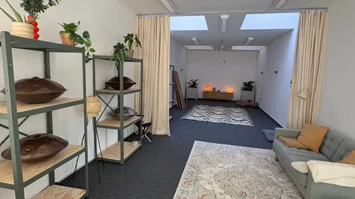 Cozy room with shelves, sofa, and rugs.