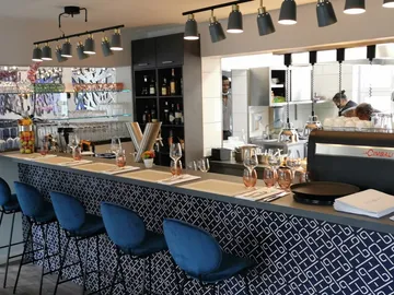 Moderne Bar mit Gläsern, Getränke werden zubereitet.