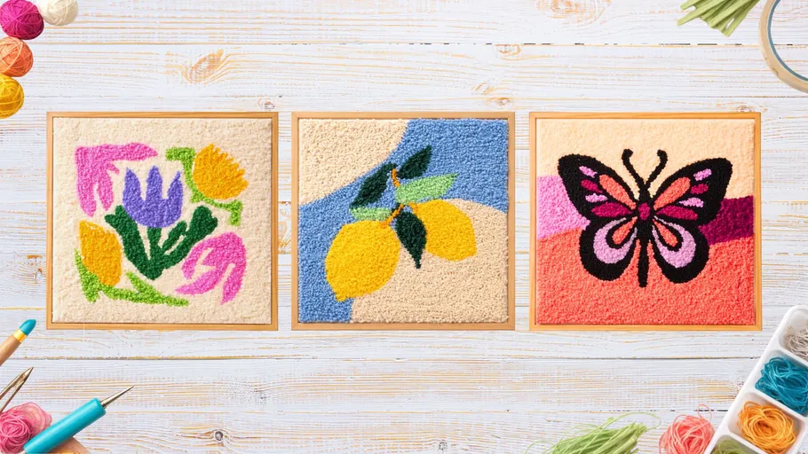 Three punch needle art pieces on wooden background.