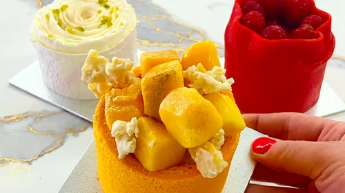 Three decorative pastries on a marble surface.