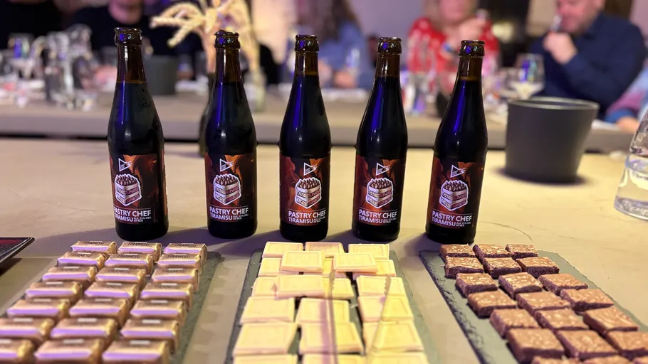 Bottles of beer with desserts on table.