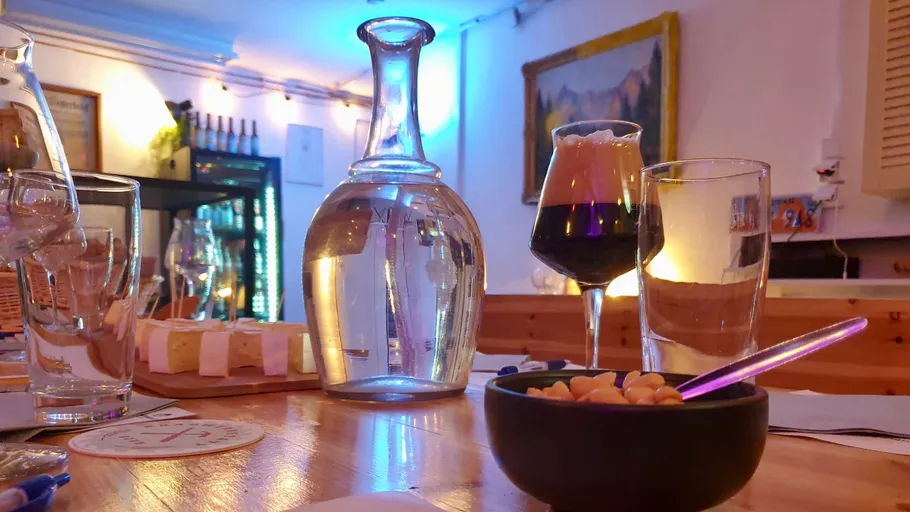 Table with drinks and snacks in a bar.
