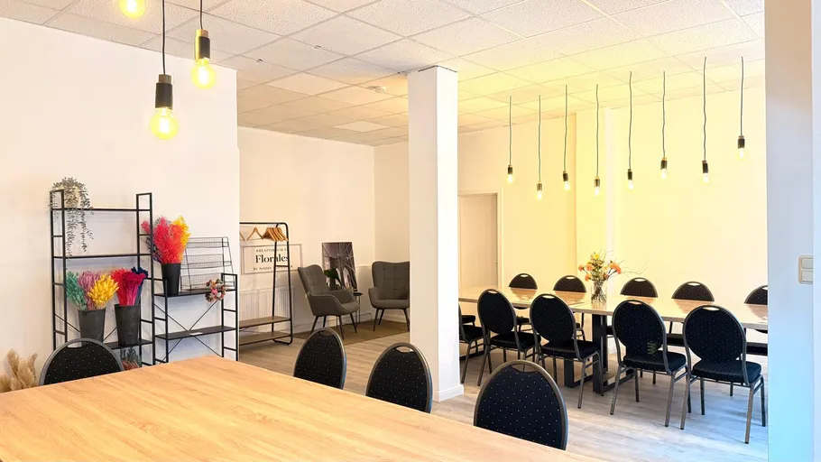 Meeting room with chairs and decorative lights.