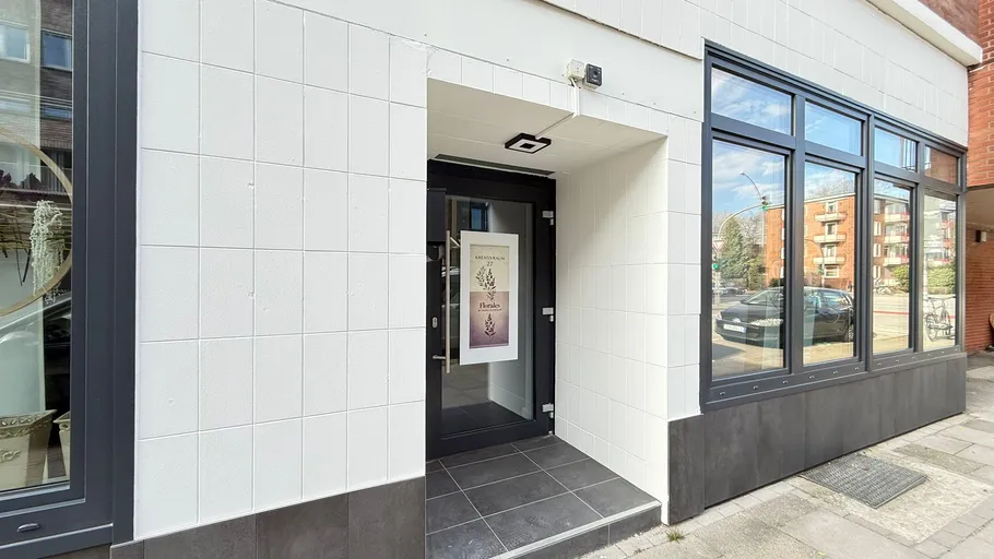 Glass door of a building with sign.