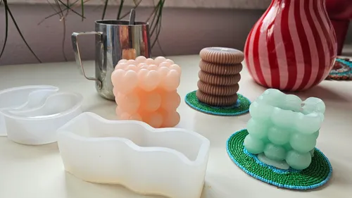 Colorful candles and molds on a table.