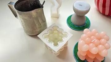 Homemade candles on a white table.