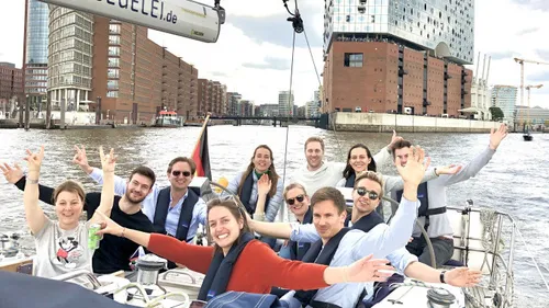 Group of people smiling on a boat.