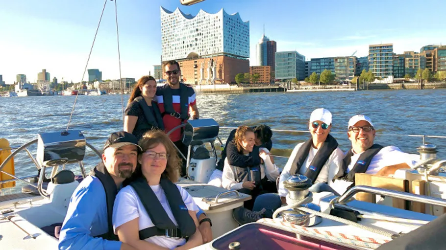 People sailing with Elbphilharmonie in the background.