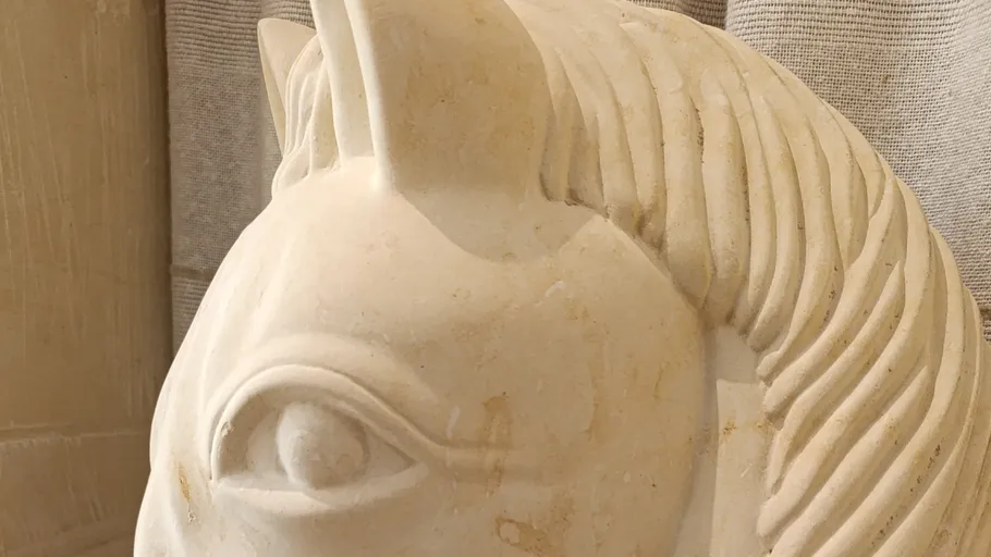 White marble horse sculpture indoors.