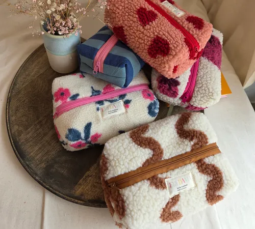 Patterned pouches arranged on a wooden tray.