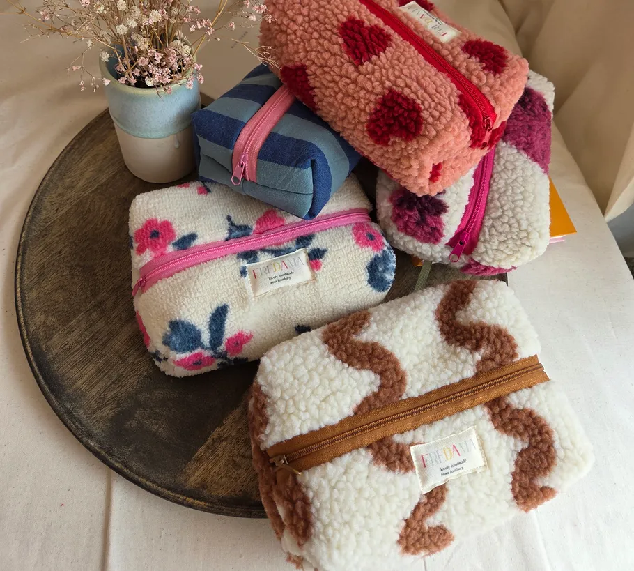 Patterned pouches arranged on a wooden tray.