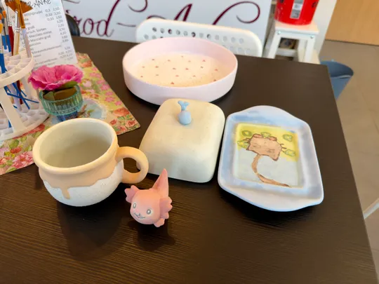Painted pottery items on a table.