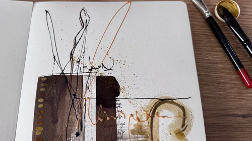 Abstract art with brushes on wooden table.