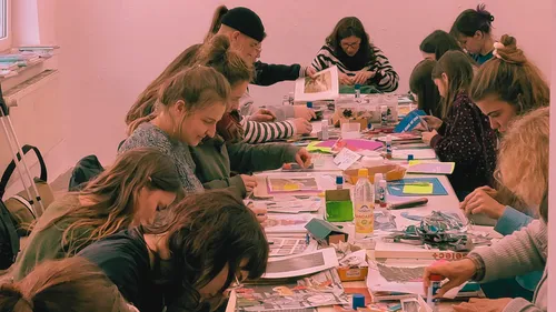 Participants crafting collages at a long table.