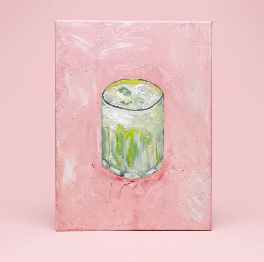 Painted glass of drink on pink canvas.