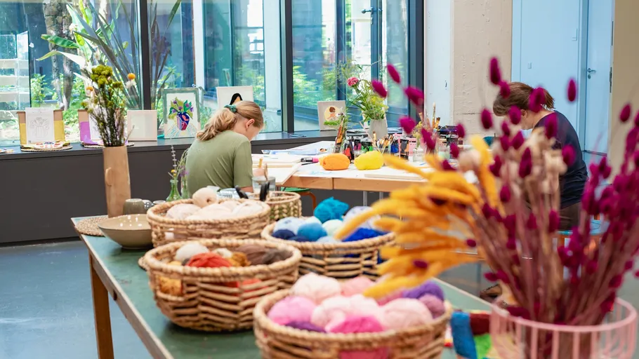 People crafting in a colorful studio.