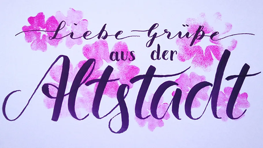 Calligraphy text with pink floral background.
