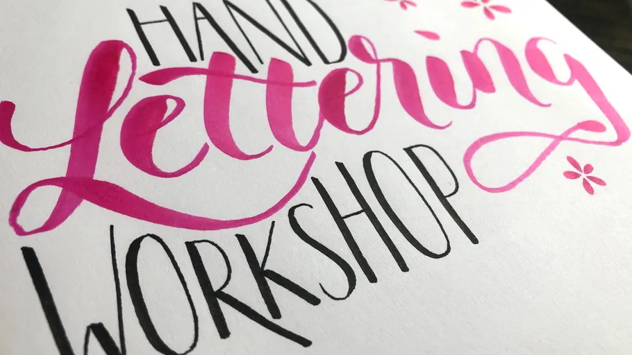 Hand-lettered workshop sign with floral accents.