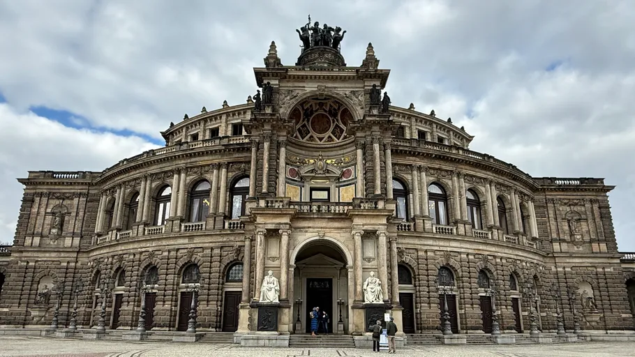 Historic opera house with ornate facade and statues.