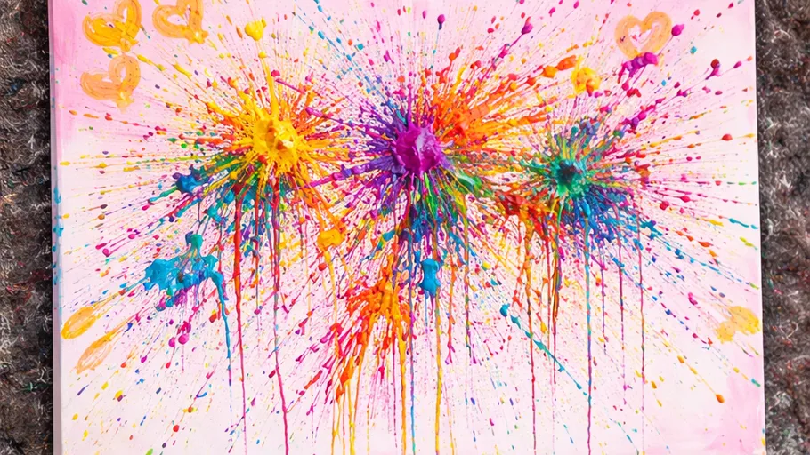 Colorful paint splatters on a canvas.