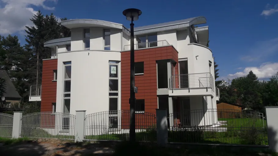 Modern house with unique architecture, green garden.