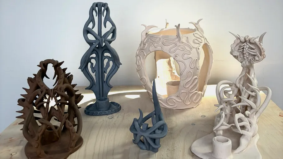 Intricate ceramic sculptures on a wooden table.