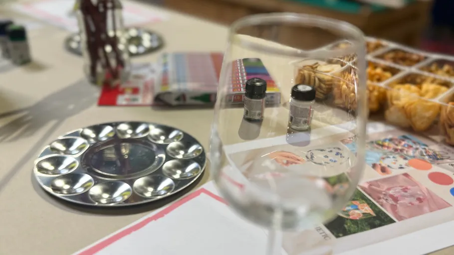 Empty glass with art supplies and snacks.