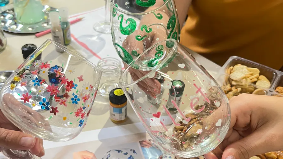 Three decorated wine glasses clinking together.