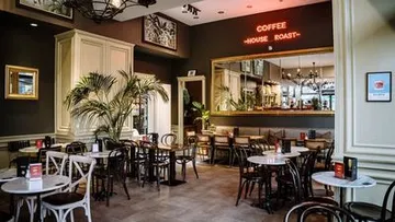 Cozy cafe with neon sign, elegant decor.