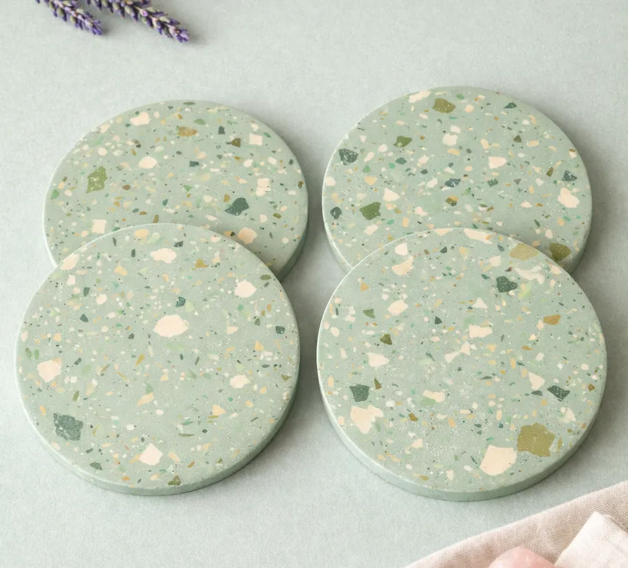 Four terrazzo coasters on a light background.