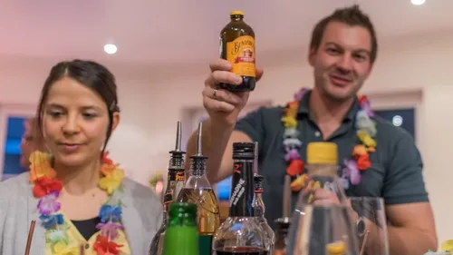 Two people at a party with drinks.