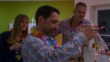 People making drinks at a party.