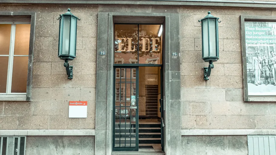 Building entrance with glass door and signage.