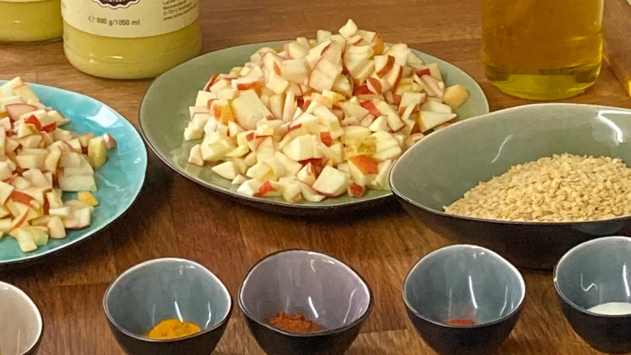 Chopped apples and spices on wooden table.
