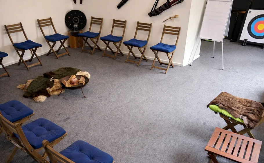 Wooden chairs in circle with blue cushions.