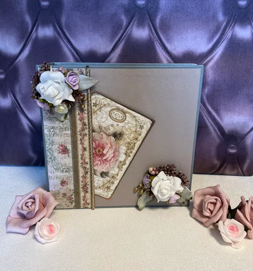 Decorative scrapbook with floral cards and embellishments.