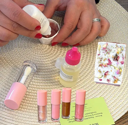 Hands mixing beauty products on table.