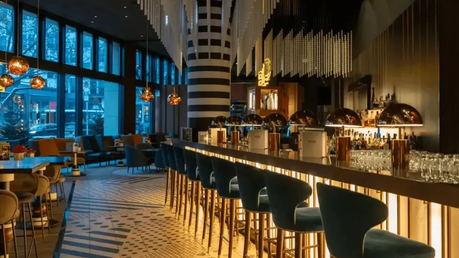 Modern bar with stools and ambient lighting.