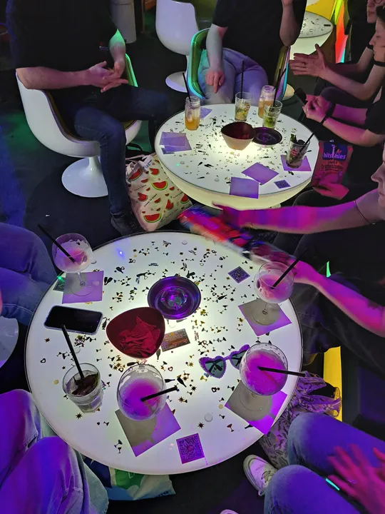 People sitting at round table with drinks.